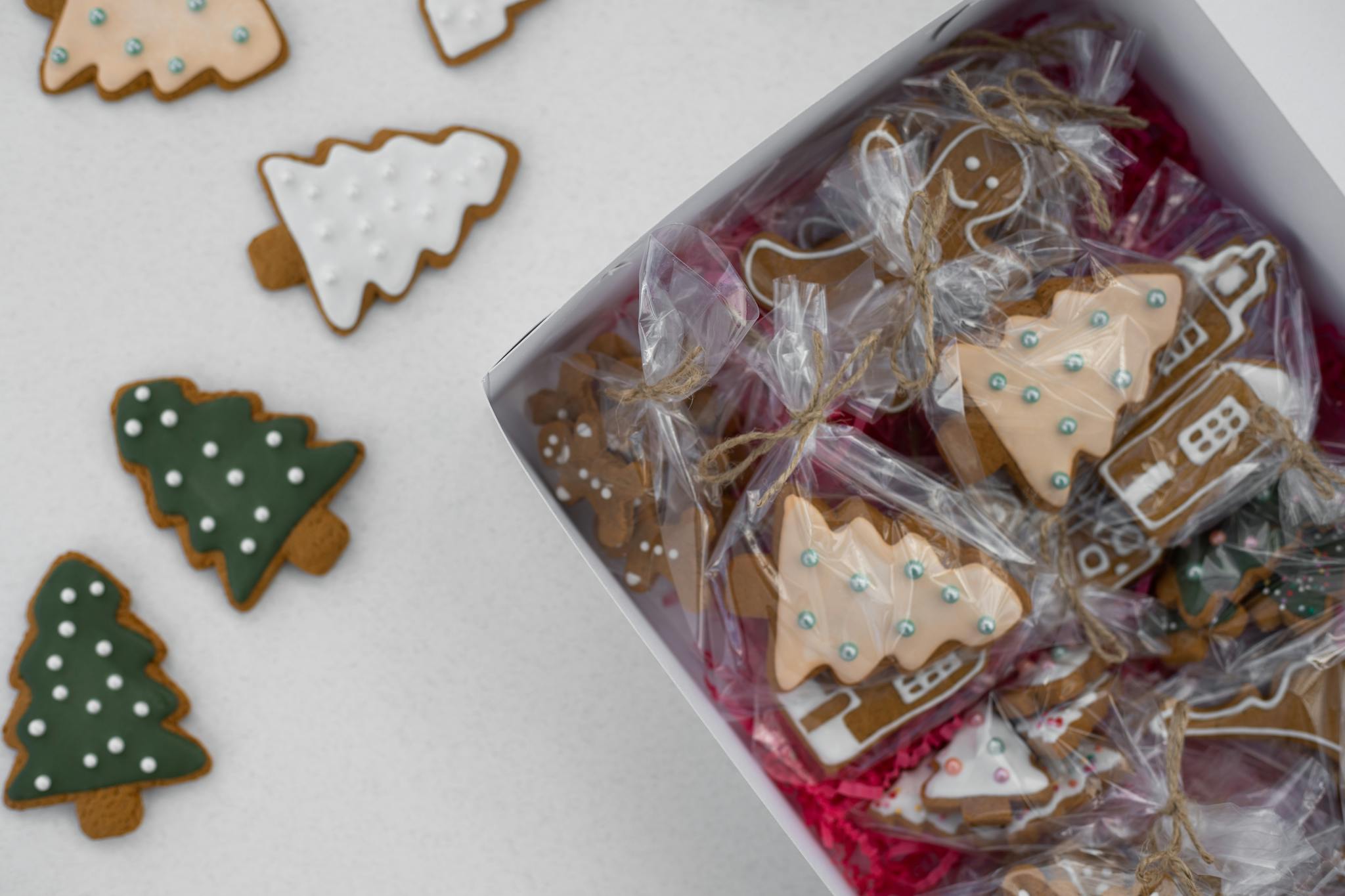 Decorative gingerbread cookies shaped like Christmas trees, perfect for holiday gifts.