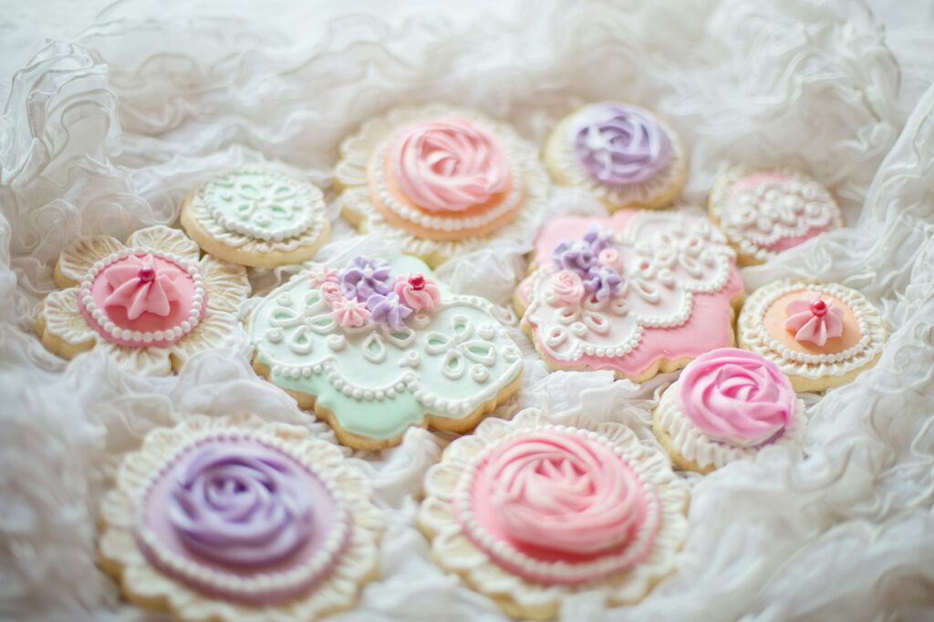 Delicate pastel decorated sugar cookies with intricate icing designs for special occasions.